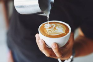 a man making art on coffee - darren yaw cambodia